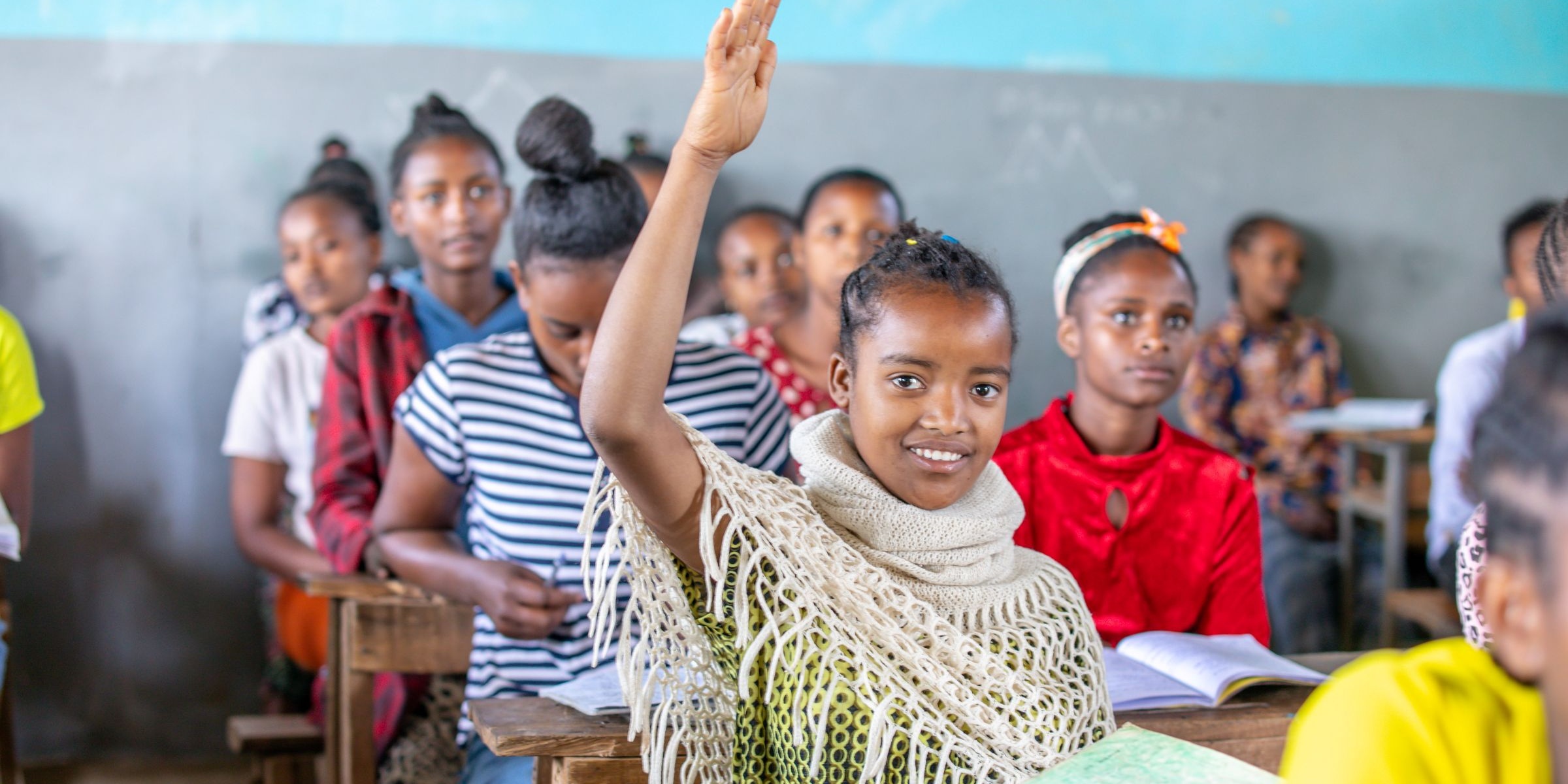 A student lifts their hand in class. Yirba Yanase Primary and Secondary School is located in Hawassa, Ethiopia. Credit: GPE/Translieu