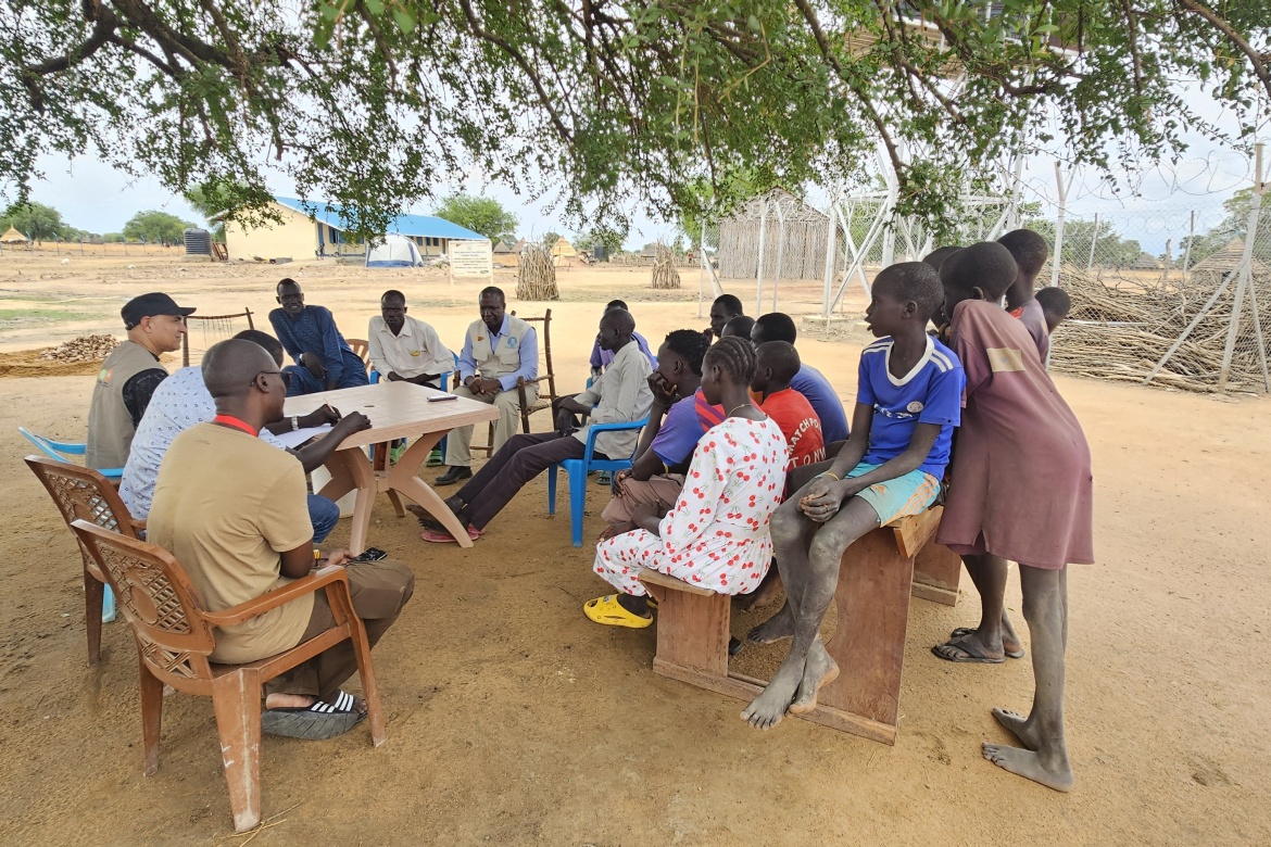 A community engagement meeting takes place outside of the newly constructed classrooms at Ngapaneet Primary School, Warrap State. Credit: Save the Children